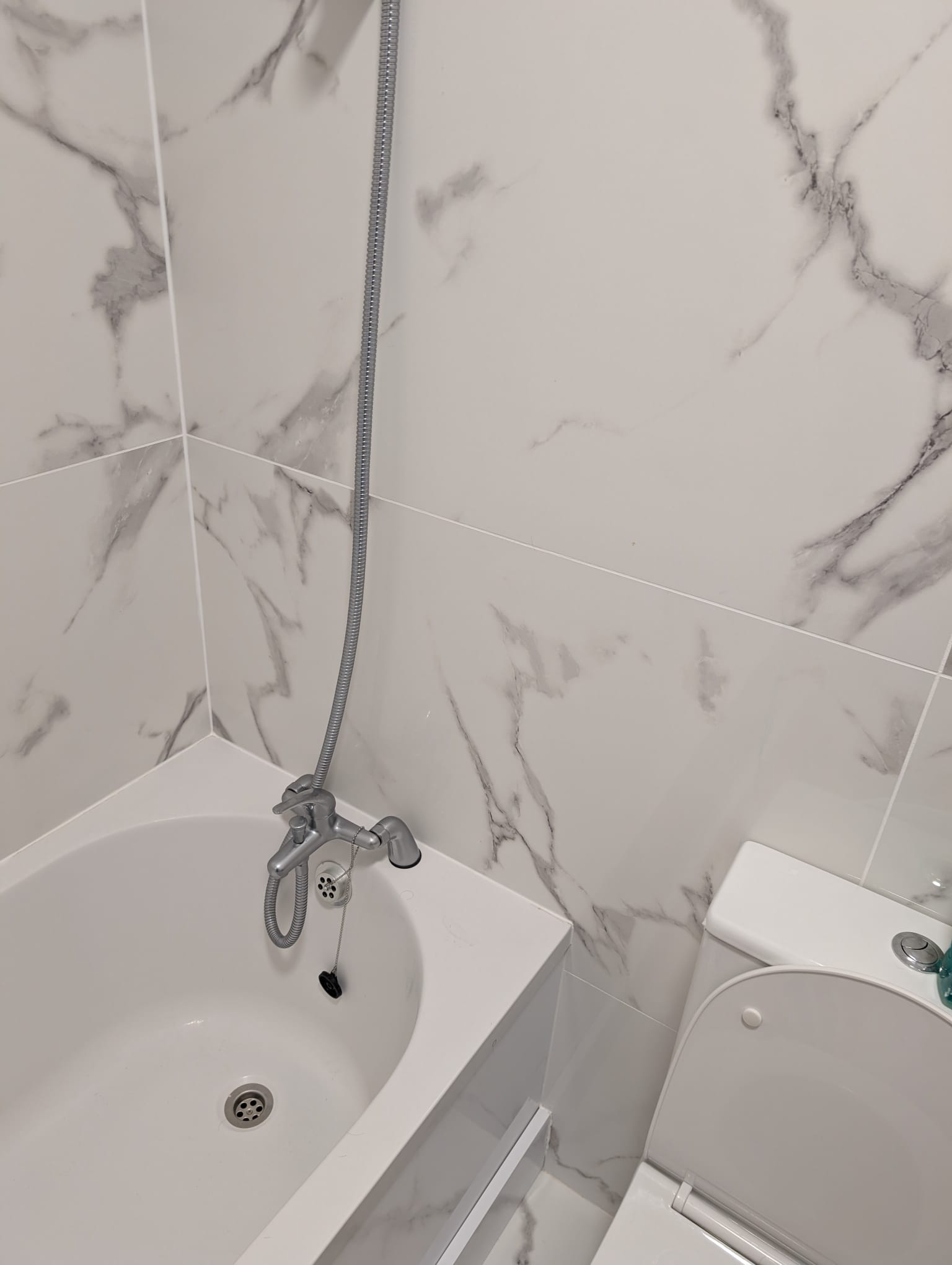 Bathtub and marble-effect tiling fitted in compact Dublin bathroom renovation