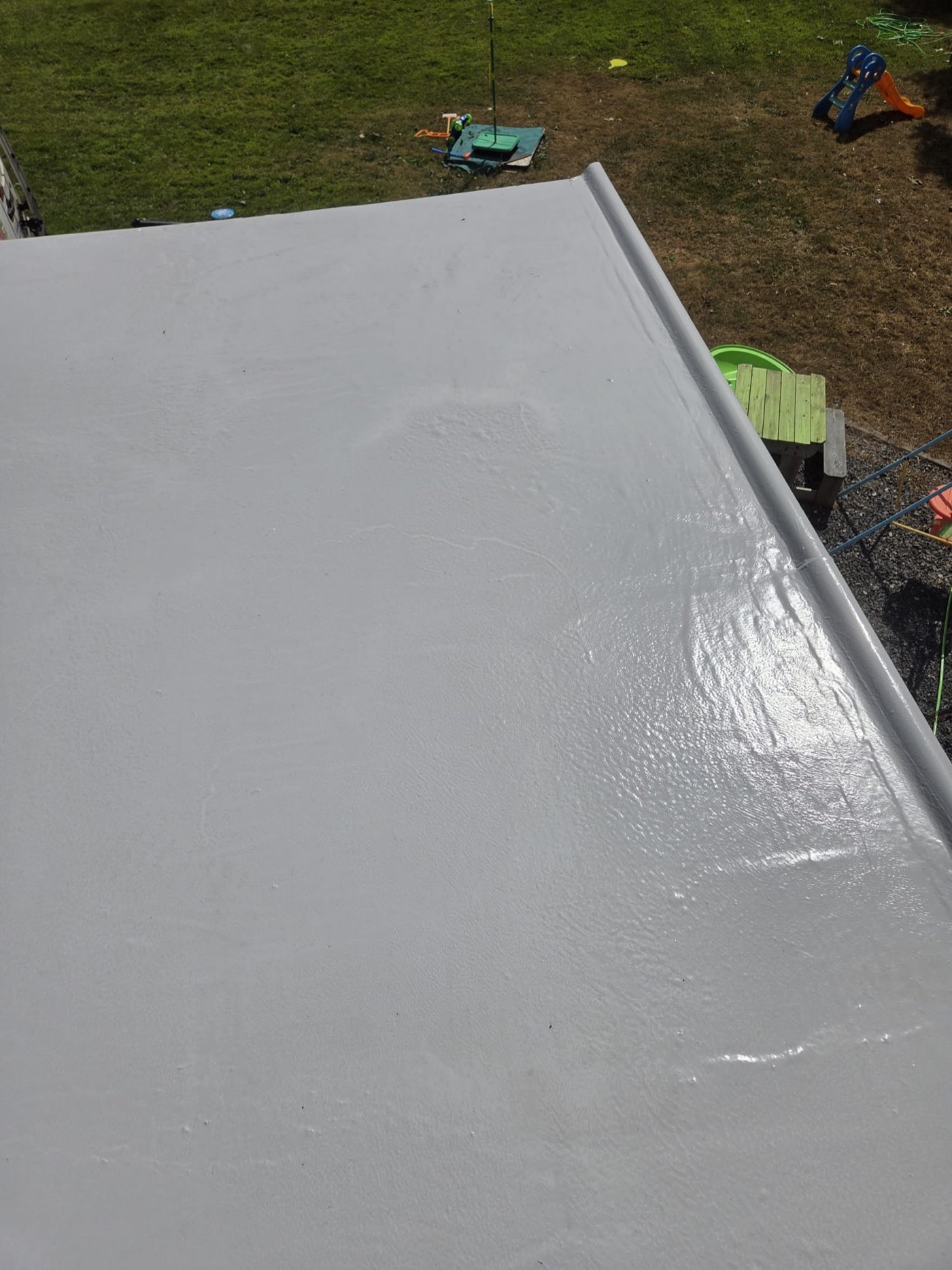 Flat roof waterproofed with grey liquid rubber coating by handyman in Dublin